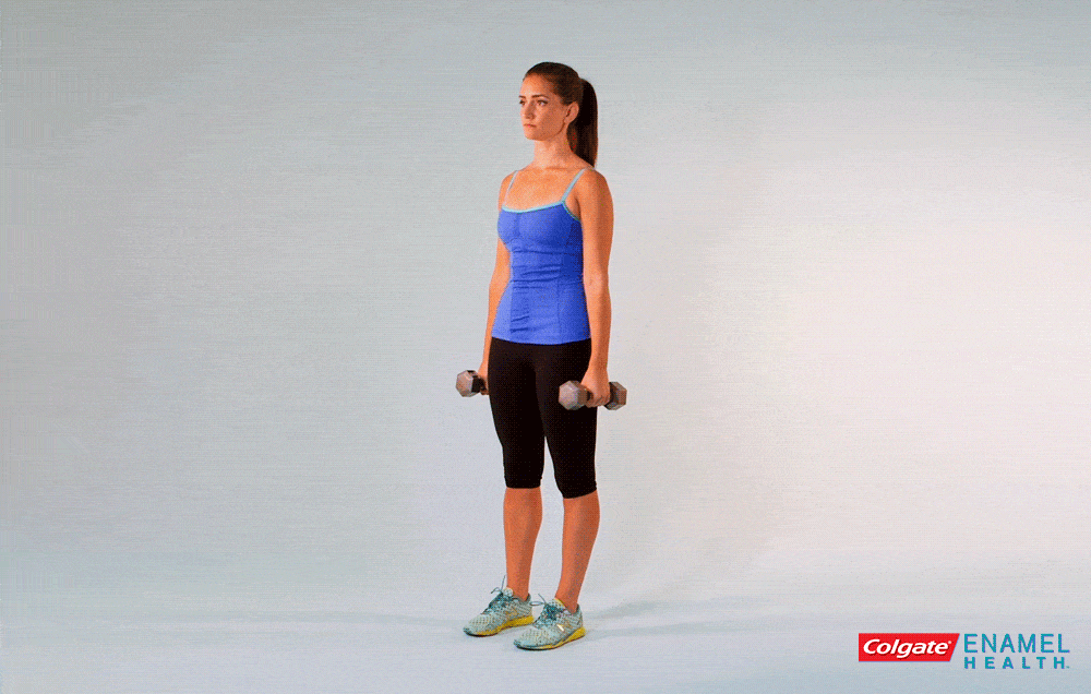 holding a dumbbell in each hand, let your arms hang by your