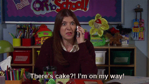 Lily from How I Met Your Mother is on the phone, passionately declaring "There's cake?! I'm on my way!"