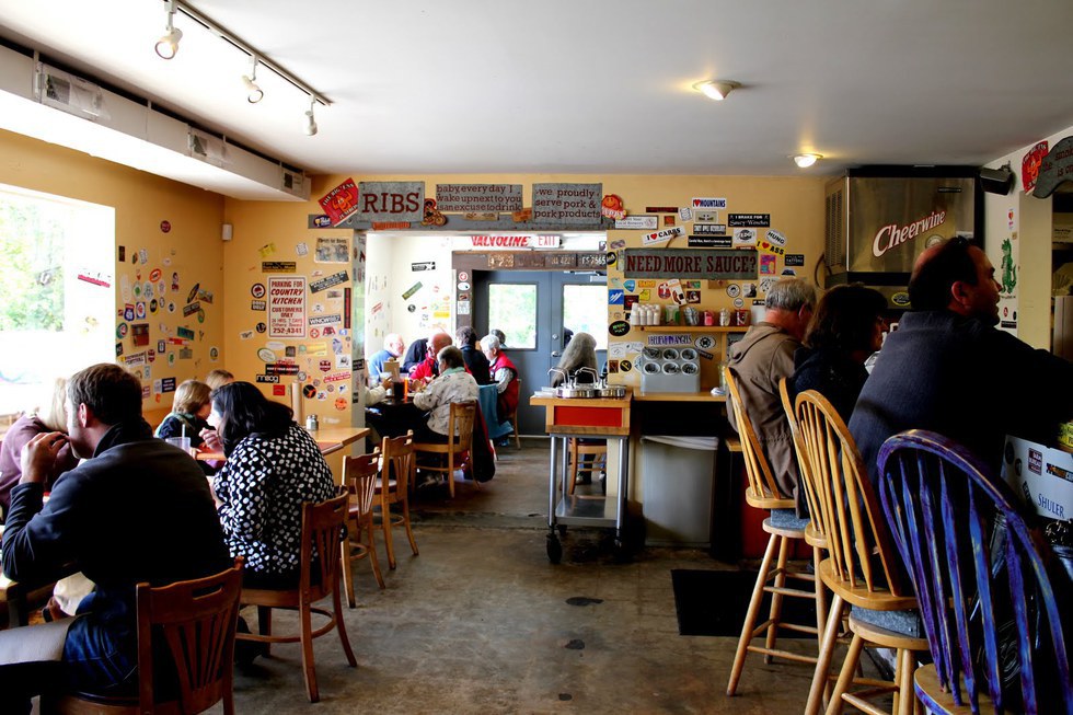 7 Great Places Locals Eat At In Asheville Nc The Interior Of Building Is Covered In Per Stickers And Writing On Walls It Looks Like A Dive But Food To For