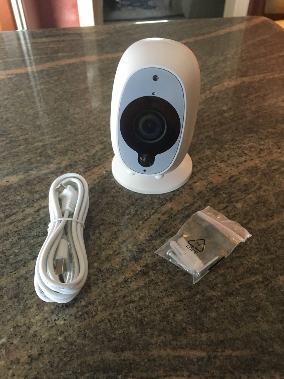 Swann Security Camera with charging cable and mounting screws.