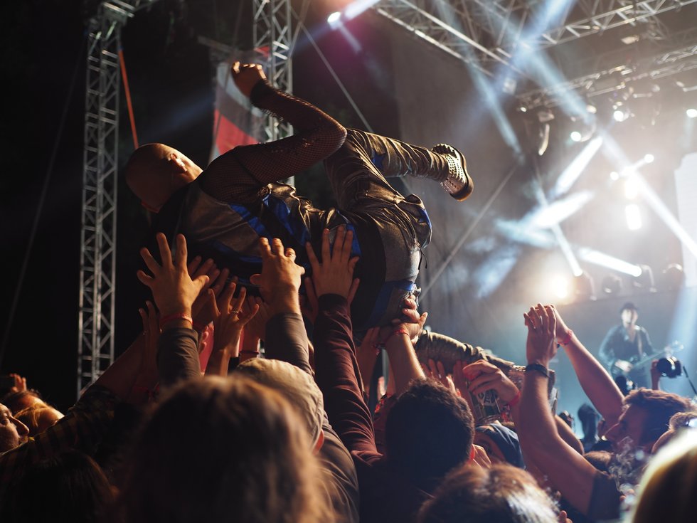 Crowd surfer held up by crowd