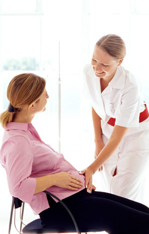 nurse talking to a pregnant patient