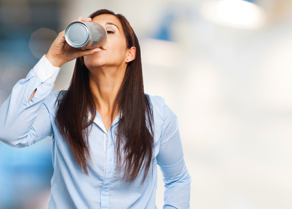 woman drinking an energy drink
