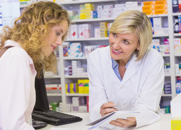 woman talking to her pharmacist
