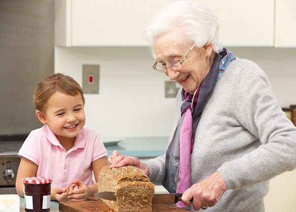 grandmother helping grandchild bake