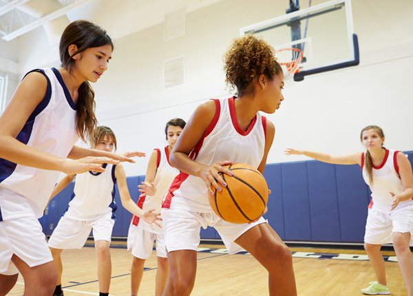 teen girls playing basketball