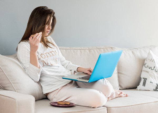 woman in pajamas using her laptop