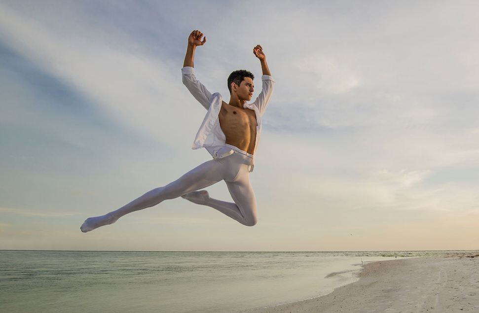 Xavier Nunez leaps on the beach at sunset