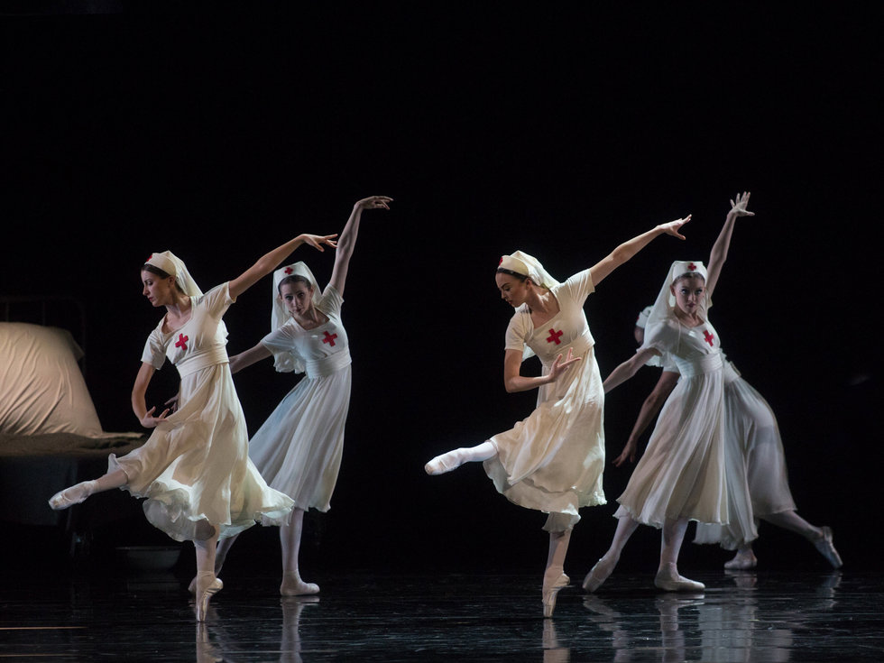 Four dancers in nurse costumes
