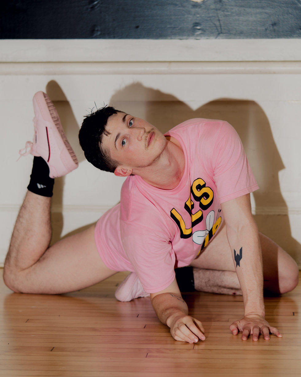 Ashley Yergens on the floor in a pink shirt