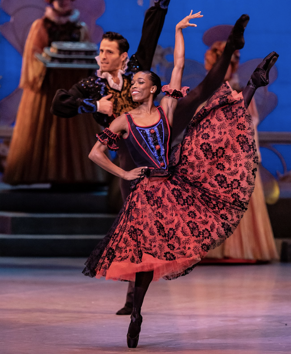 Kiara Felder in developpe a la seconde in Spanish costume for Nutcracker