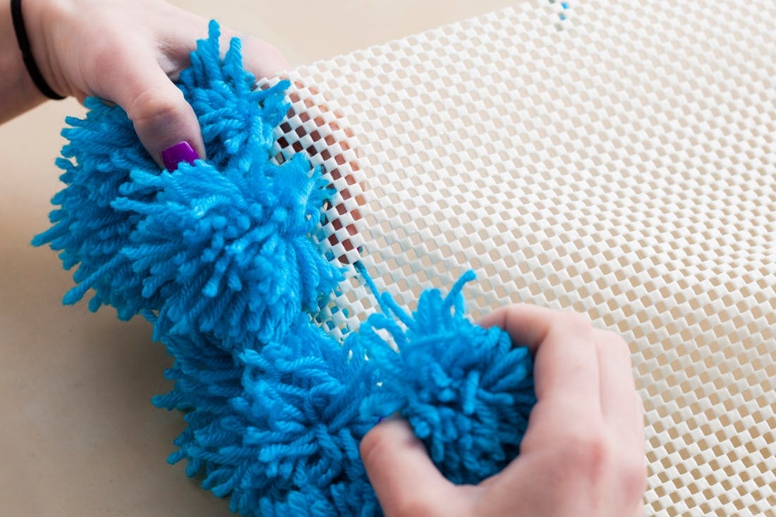 A Pom Pom Rug Wall Hanging And Table Cover In One Brit Co