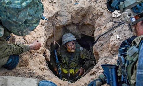Israeli soldiers uncover a Palestinian tunnel in Gaza Strip