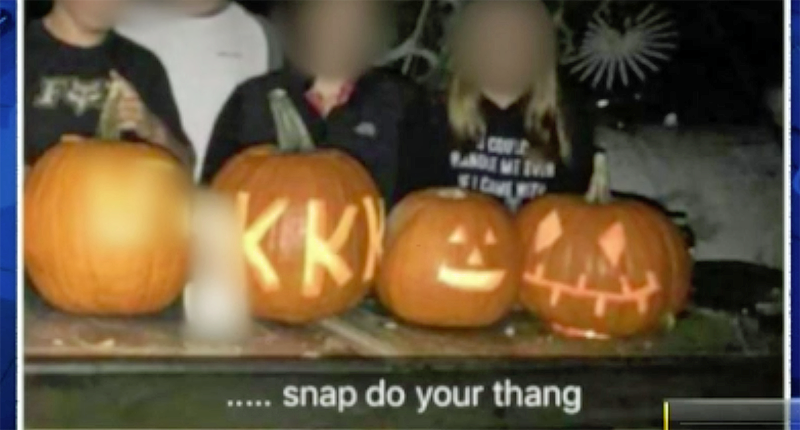 Photo of Coatesville students posing with pumpkins carved with