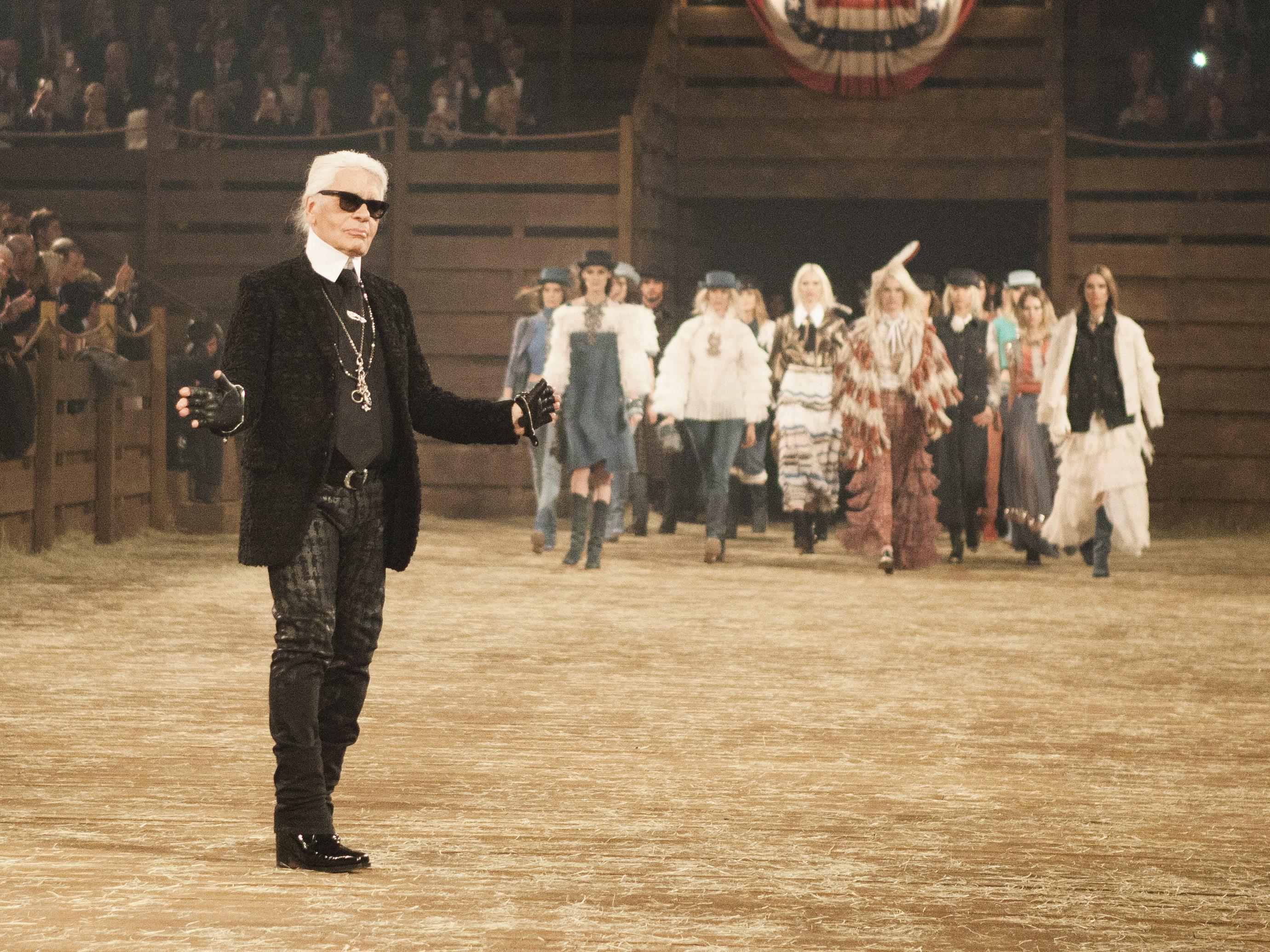 A model walks the runway at Chanel's Metiers d'Art fashion show, in Dallas,  Tuesday, Dec. 10, 2013. For more than a decade, designer Karl Lagerfeld has  picked a city linked to the