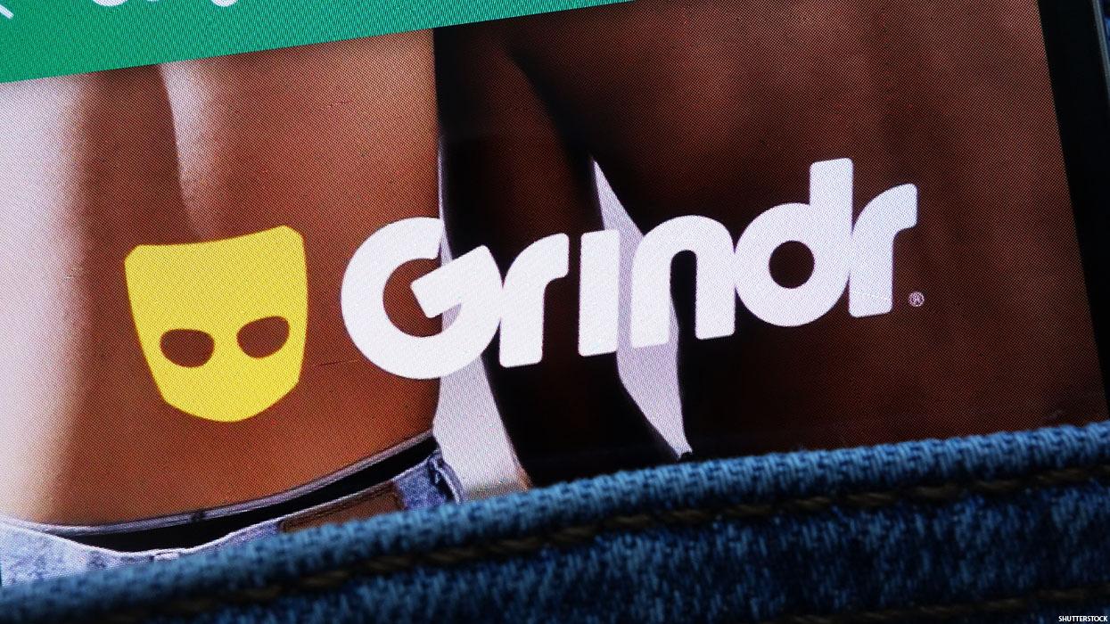 The Grindr Logo on an image of the backs of a white and Black body.