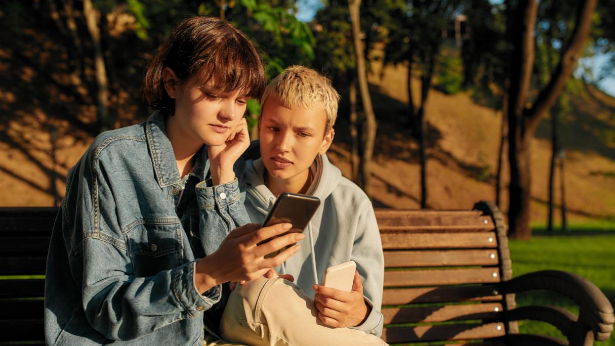 Young people on phones in a park