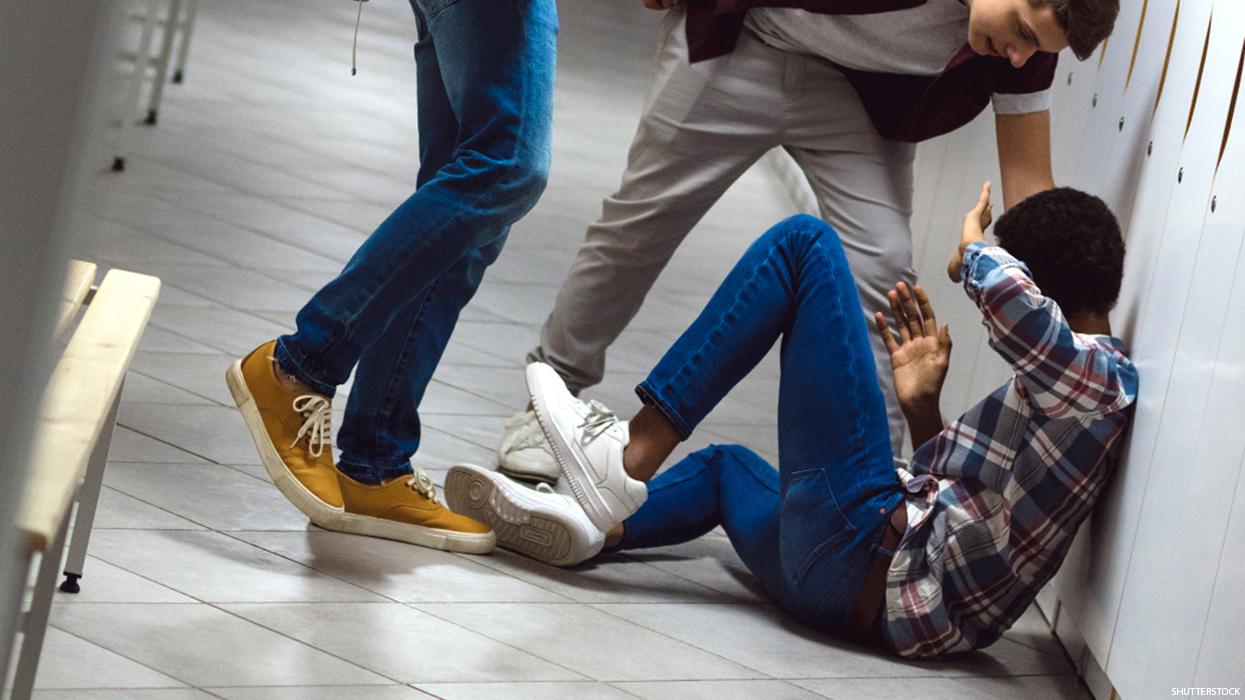 A group of kids attacking a student.