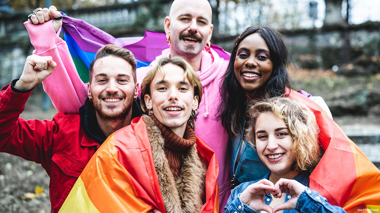 Queer people wrapped in pride flags