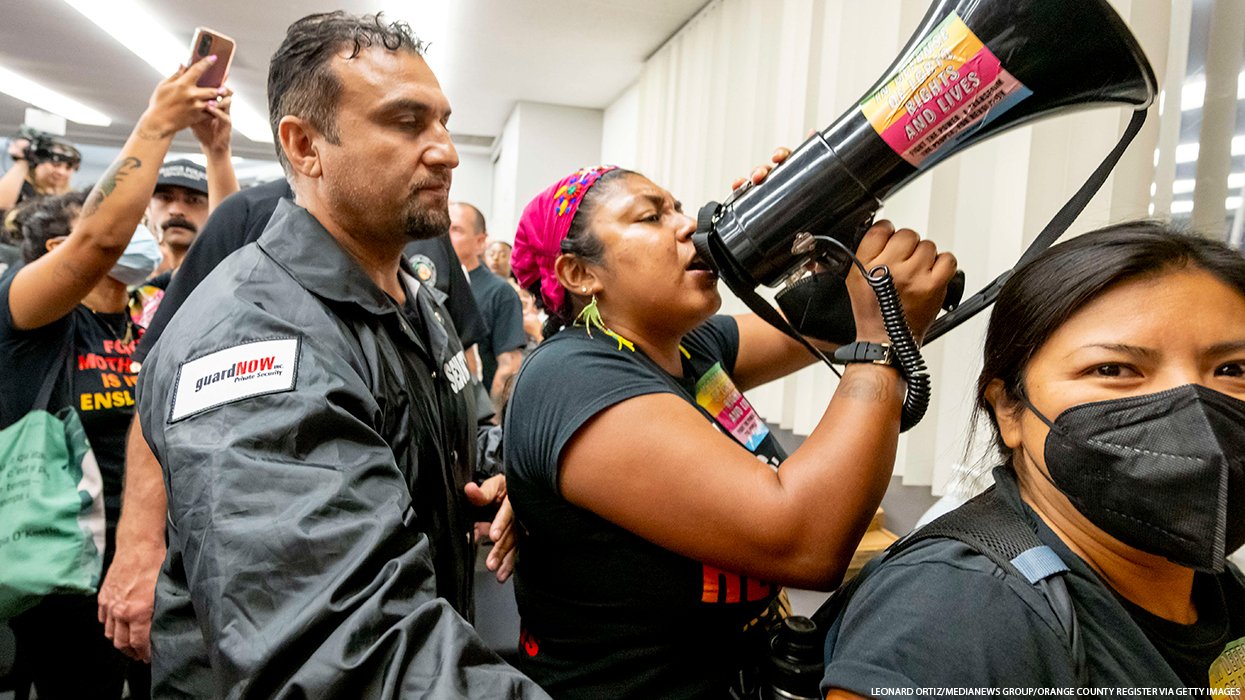 Security guard and protester at Orange Unified meeting