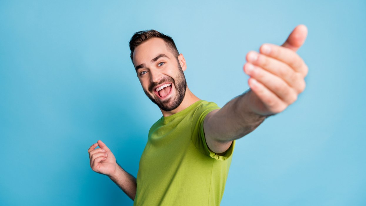 Man smiling and inviting someone in