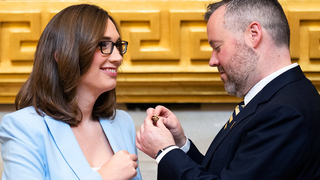 Roddy Flynn chief of staff for incoming Congresswoman Sarah McBride affixes her member pin to her lapel in the US Capitol Rotunda on Friday morning January 3rd 2025 before being sworn in for the 119th Congress