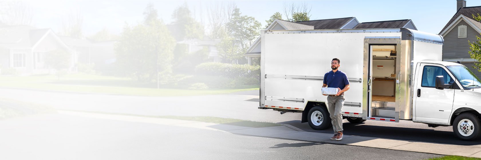 Delivery man dropping off a package to a home