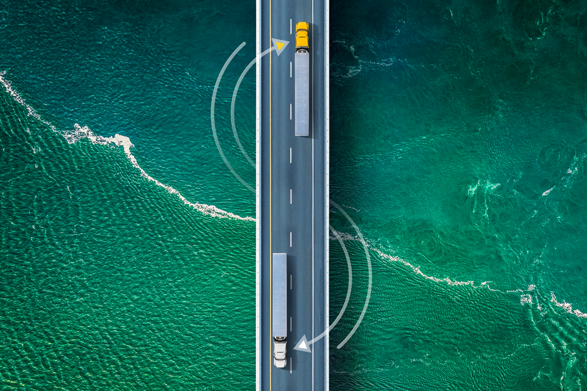 Penske trucks crossing a bridge