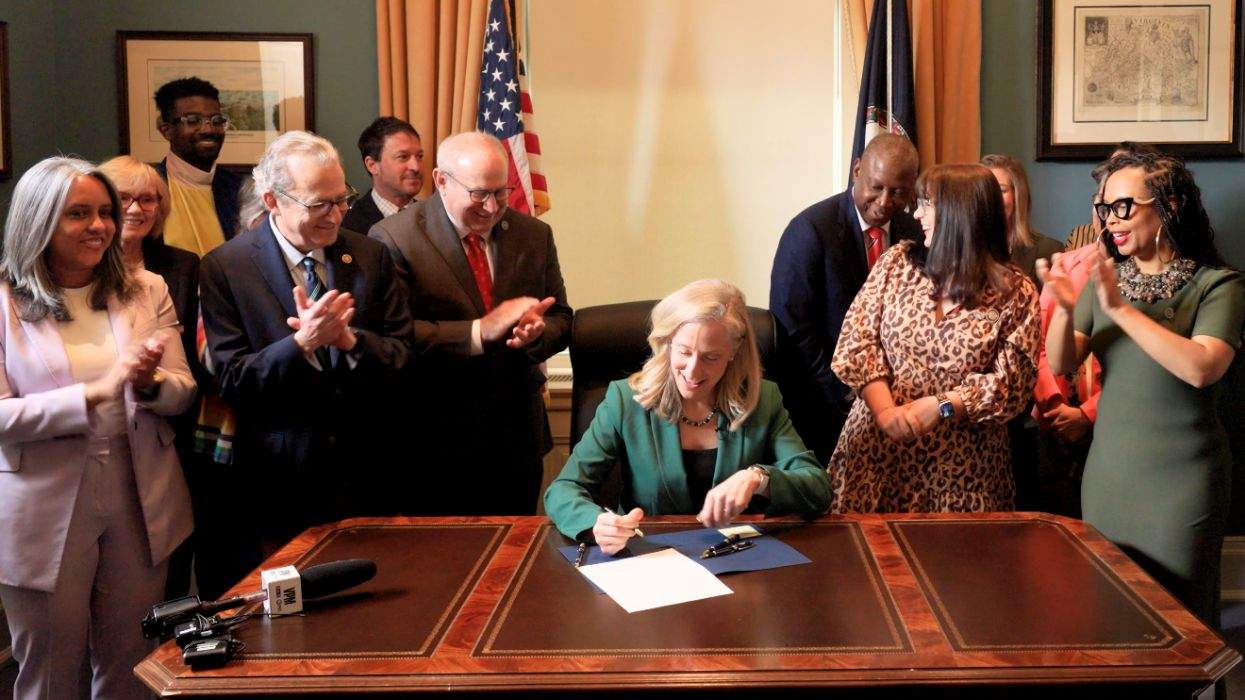 abigail spanberger signing a piece of legislation alongside advocates