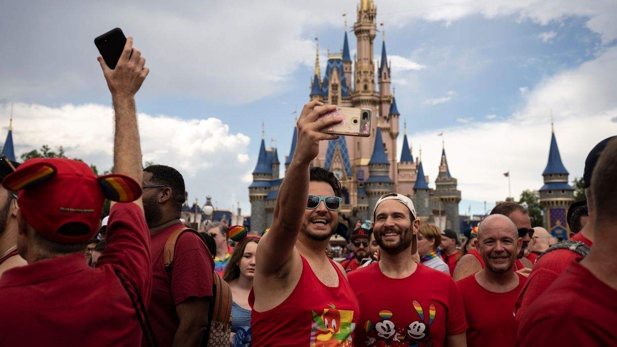vacationers take photos in front of the disney world cinderella castle