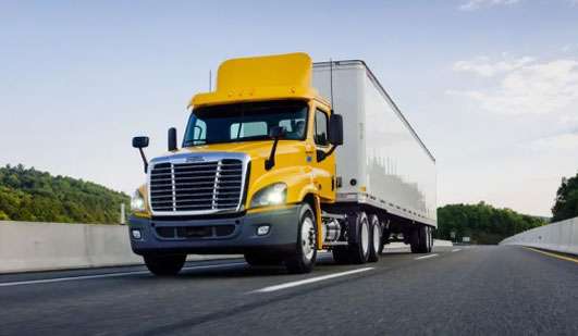 Heavy duty tractor trailer on a highway overpass
