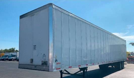An large, unattached trailer sitting in a parking lot