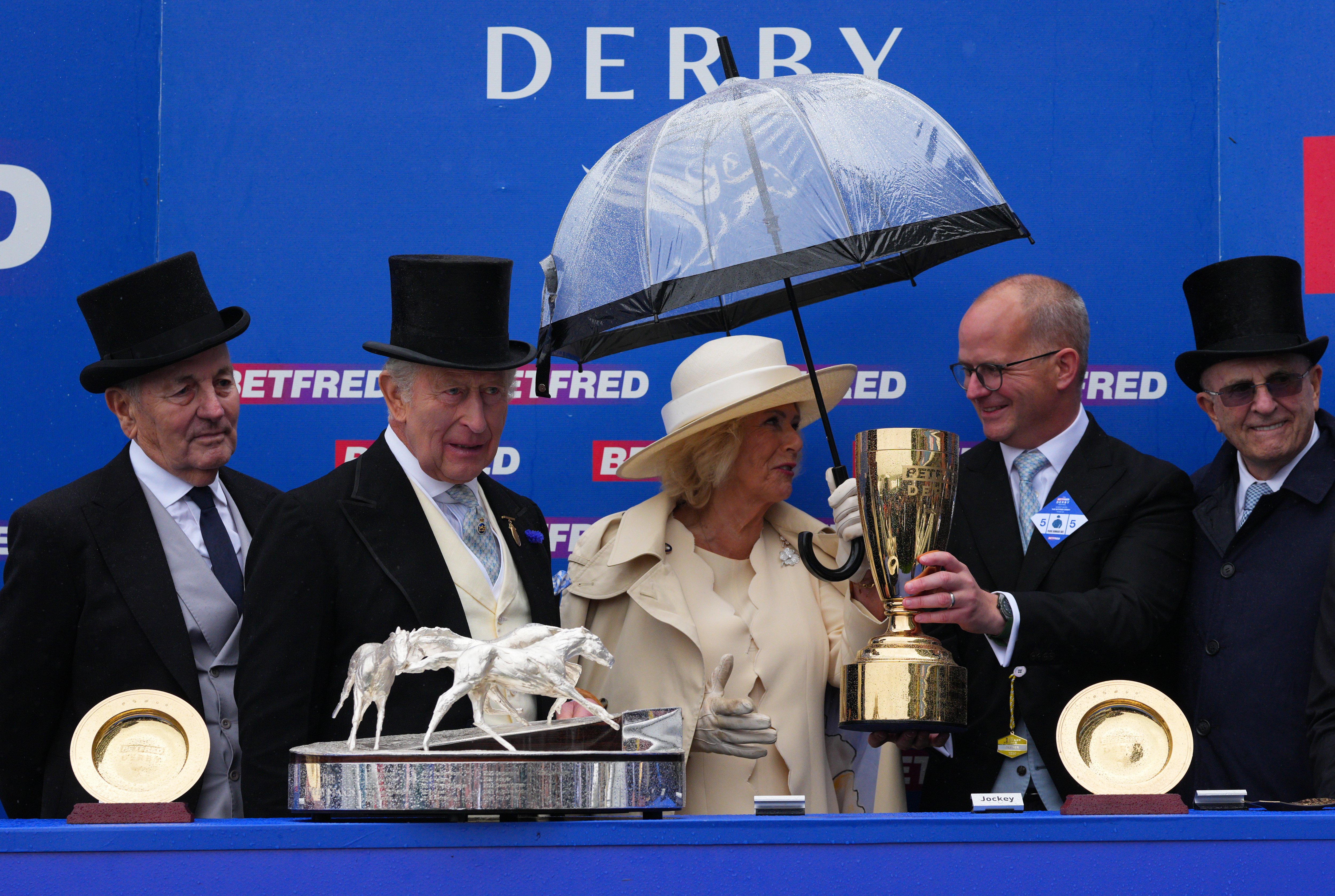 King and Queen hand out prestigious trophy at Epsom just hours after watching Peter Phillips wedding
