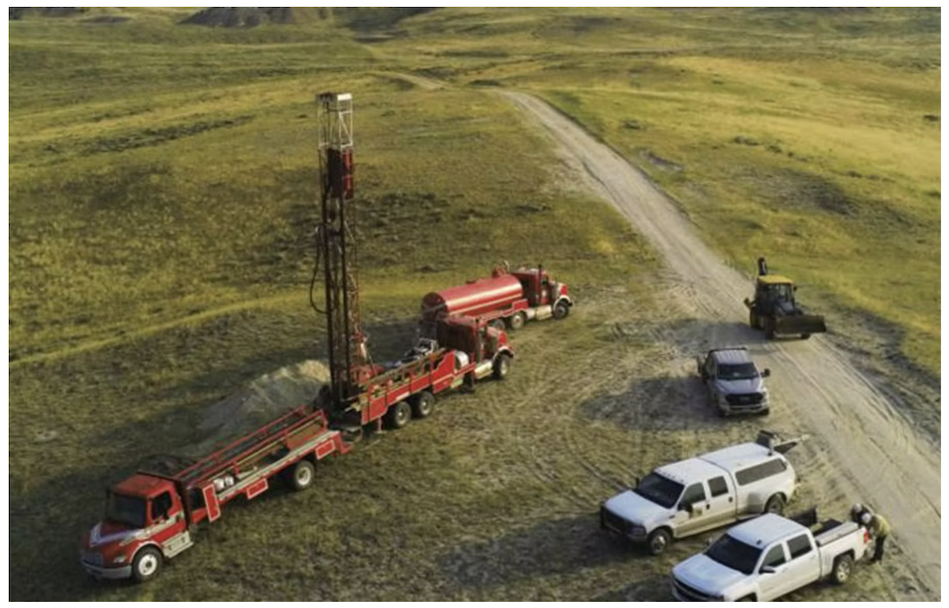 trucks on a grassy field at American Uranium's Lo Herma property