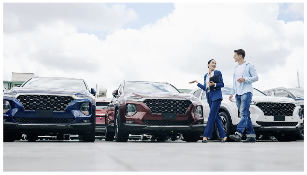 AmeriTrust Financial Technologies staff showcasing cars to a client