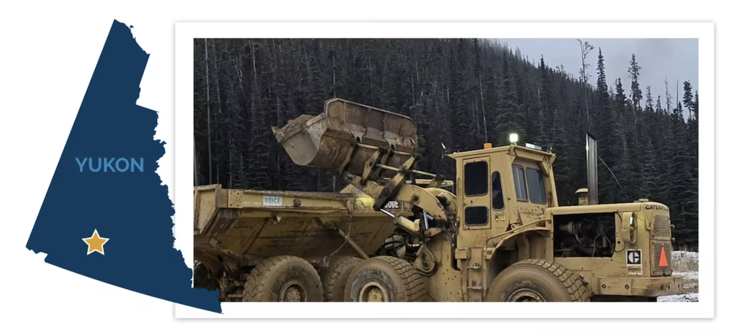 A yellow front loader in snowy forest; map of Yukon with star; text reads: YUKON.