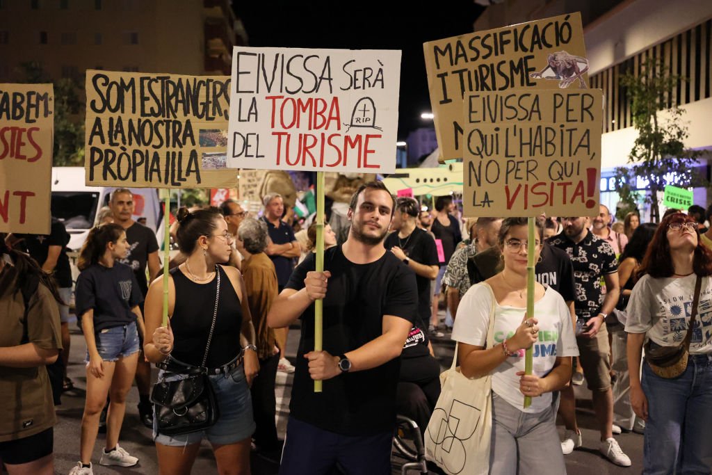 Anti-tourism protesters revolt at popular British holiday destination as they lash out at 'overcrowded' beach