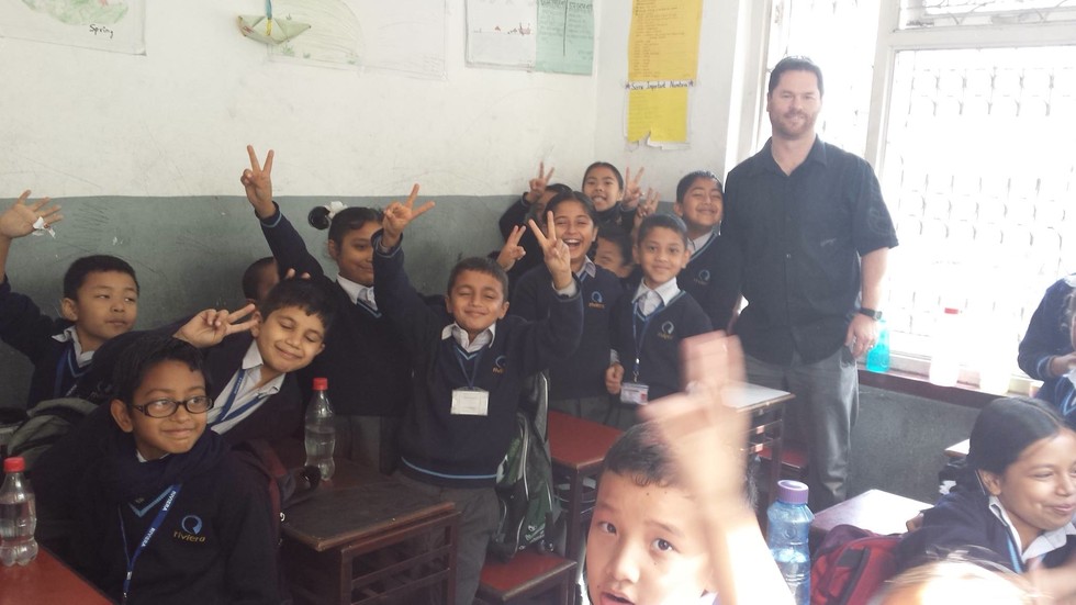 Gavin Howell in classroom with students