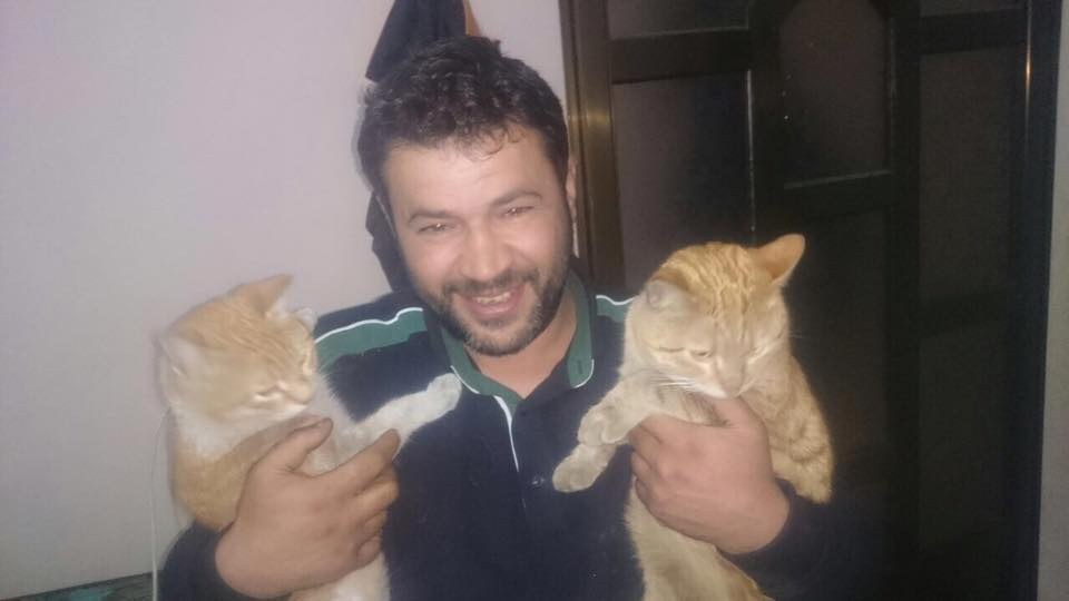 Alaa with two rescue cats
